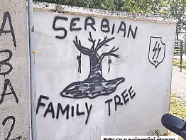 A modern graffiti in Croatia, showing a tree with hung people and inscription "Serbian family tree" above and below it. To to the right is a shield with the SS "runes" on it.