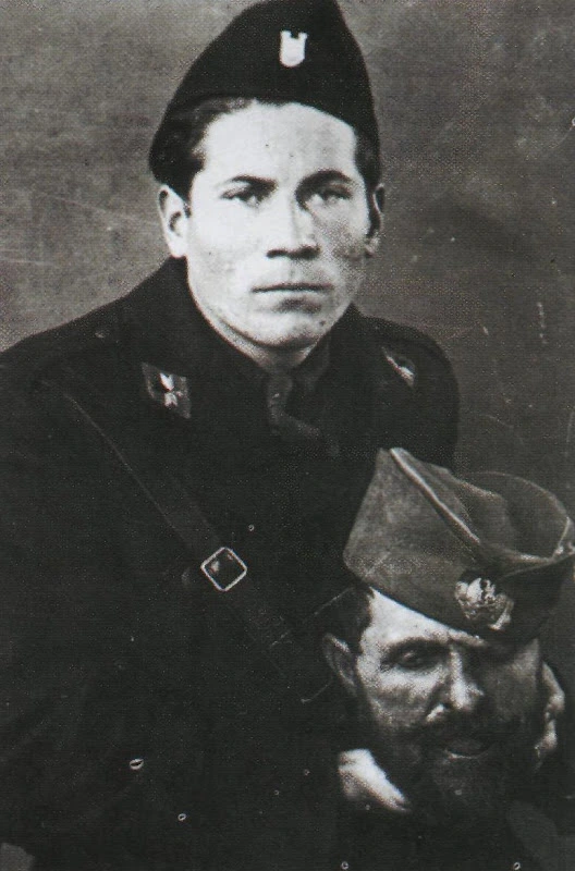 A Croatian ustasa with the severed head of a Serbian chetnik. Possibly Petar Brzica.